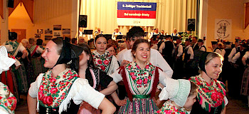 tanzende Frauen in der traditionellen Tracht der Sorben um Hoyerswerda mit bestickten Blusen und gemusterten Röcken bei einem Trachtenball in Zeißig. Foto von Johann Tesche